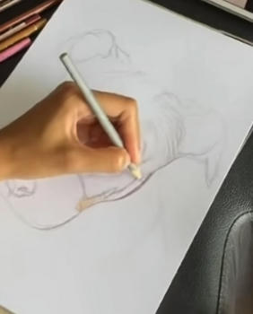 Step 2 of a portrait taking shape, from pencil to finished